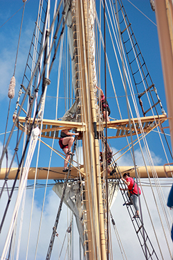 Students attend to sails onboard the boat