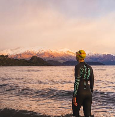 Livi Schmid stands facing Lake Wanaka in New Zealand.