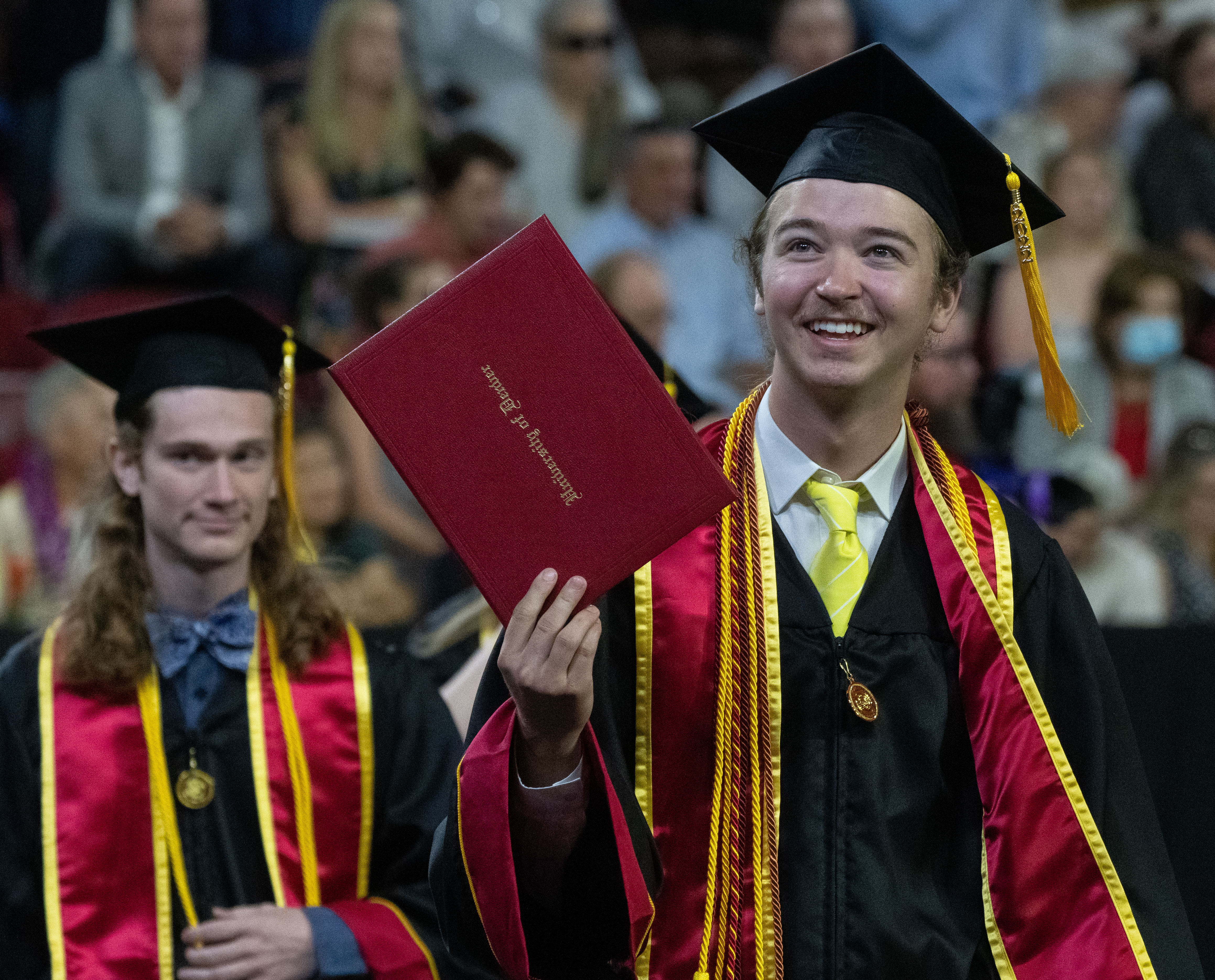 Two undergraduate graduates of DU at the 2022 commencement ceremony.